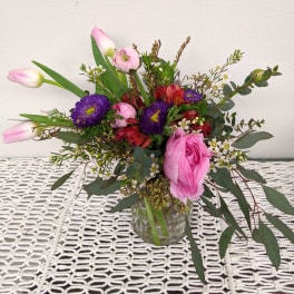 Pink and purple mixed bouquet in a clear glass vase