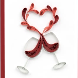 Two wine glasses with a red paper heart design on a white card