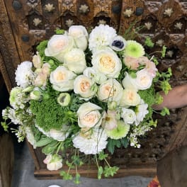 White and pale peach bouquet with green accents