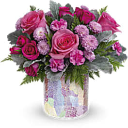 Pink rose bouquet in a patterned glass vase