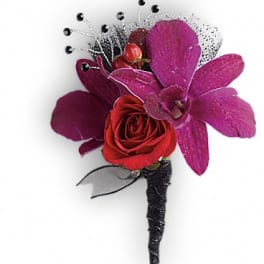 Red rose and purple orchid boutonniere with black accents