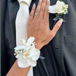 White orchid boutonniere and wrist corsage on formal black attire