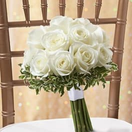 White rose bouquet with greenery on a chair