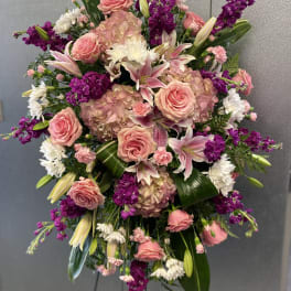 Large bouquet of pink roses, lilies, and purple flowers