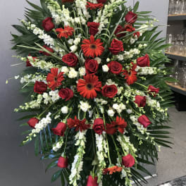 Large standing spray of red roses, red gerbera daisies, and white snapdragons