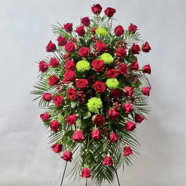 Standing spray of red roses with green pompons and palm fronds