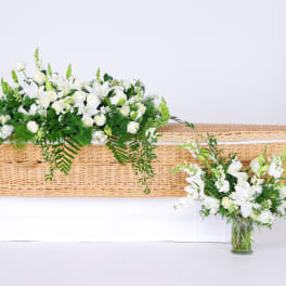 White floral casket spray with a matching vase arrangement