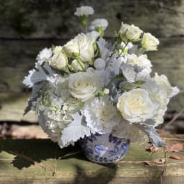 White rose bouquet in a blue-and-white ceramic vase