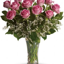 Pink roses arranged in a clear glass vase