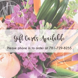 Gift card sign over a bouquet of pink and purple flowers