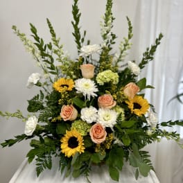 Mixed bouquet with sunflowers, peach roses, and white blooms