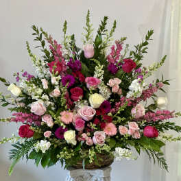 Large basket arrangement of pink, white, and magenta flowers