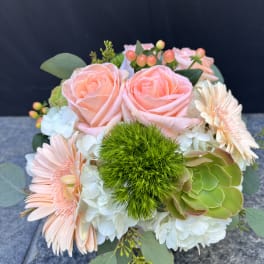 Bouquet of peach roses, pale gerbera daisies, and white hydrangeas