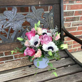 Pink and white flower arrangement in a ribbed vase