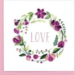 Pink floral wreath card with the word LOVE in the center