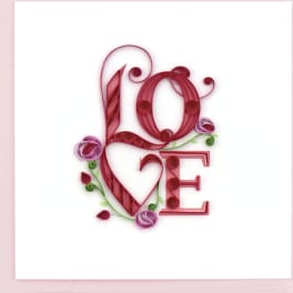 Greeting card with pink quilled paper letters spelling LOVE and small stylized flowers