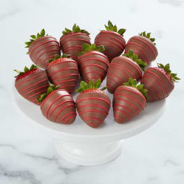 Chocolate-covered strawberries arranged on a white pedestal stand