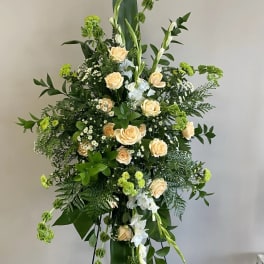 Tall floral standing spray with peach roses and white blooms