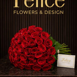 Large bouquet of red roses with a small brand card