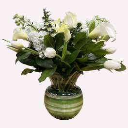 White flowers arranged in a green striped glass vase