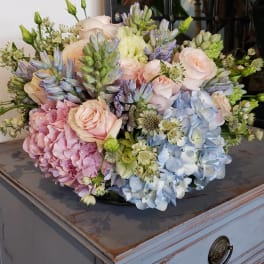 Pastel bouquet of hydrangeas, roses, and small white flowers