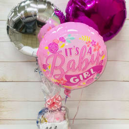 Baby girl balloon bouquet with pink gift basket wrapped in cellophane