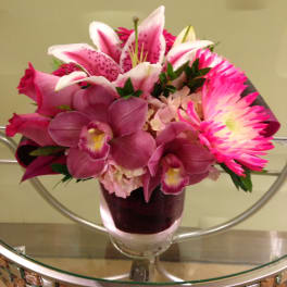 Pink and white mixed flower arrangement in a glass vase