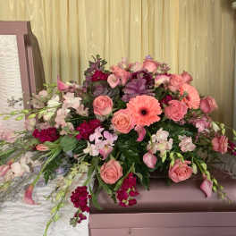 Pink and peach floral casket spray with roses and gerbera daisies
