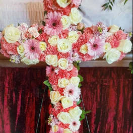 Large floral cross covered in pink and white flowers