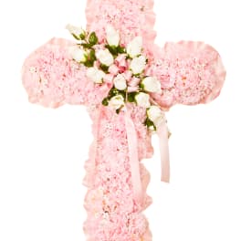 Pink carnation cross with white roses and pink ribbon accents on a white background