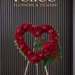 Heart-shaped red rose standing arrangement on an easel