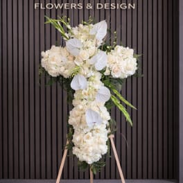 White floral standing cross on an easel