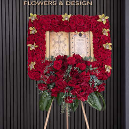 Standing floral easel with red roses and orchids around a framed tribute