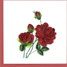 Paper-quilled red roses with green leaves on a white greeting card
