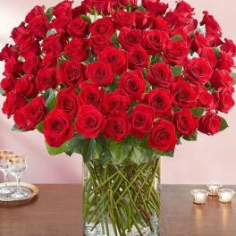 Large bouquet of red roses in a clear glass vase