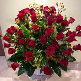 Large bouquet of red roses in a clear glass vase
