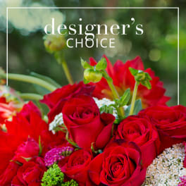 Red roses and mixed flowers in a close-up bouquet with designer's choice text