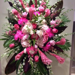Tall pink floral standing spray with roses and lilies