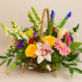 Mixed flower basket with yellow roses, lilies, gerbera daisies, and snapdragons