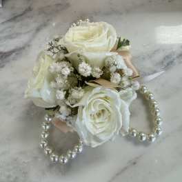 Small bouquet of white roses with pearl accents and ribbon