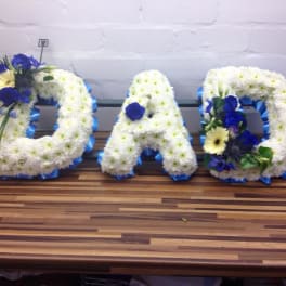 Floral letters spelling DAD in white and blue flowers
