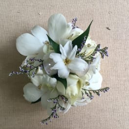 White floral bouquet with purple accents and ribbon