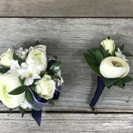 White floral bouquet and matching boutonniere with dark ribbon