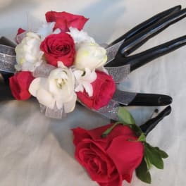 Red and white rose corsage and boutonniere with silver ribbon