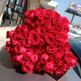 Large bouquet of red roses wrapped in paper