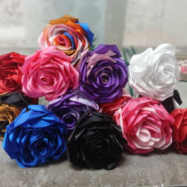 Assorted satin ribbon roses in multiple colors arranged in a cluster