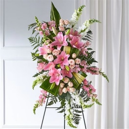 Tall pink and white standing spray with lilies and roses on a metal easel