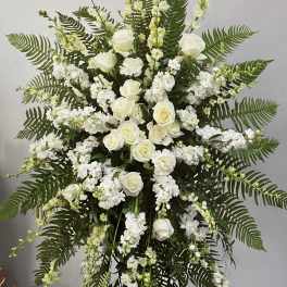 White rose and stock standing spray with fern foliage