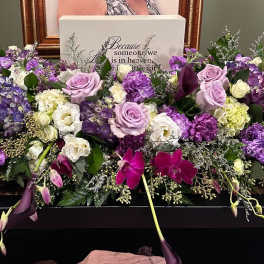 Large purple and white floral casket spray with roses and orchids