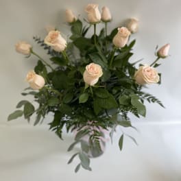 Bouquet of pale peach roses with greenery in a vase